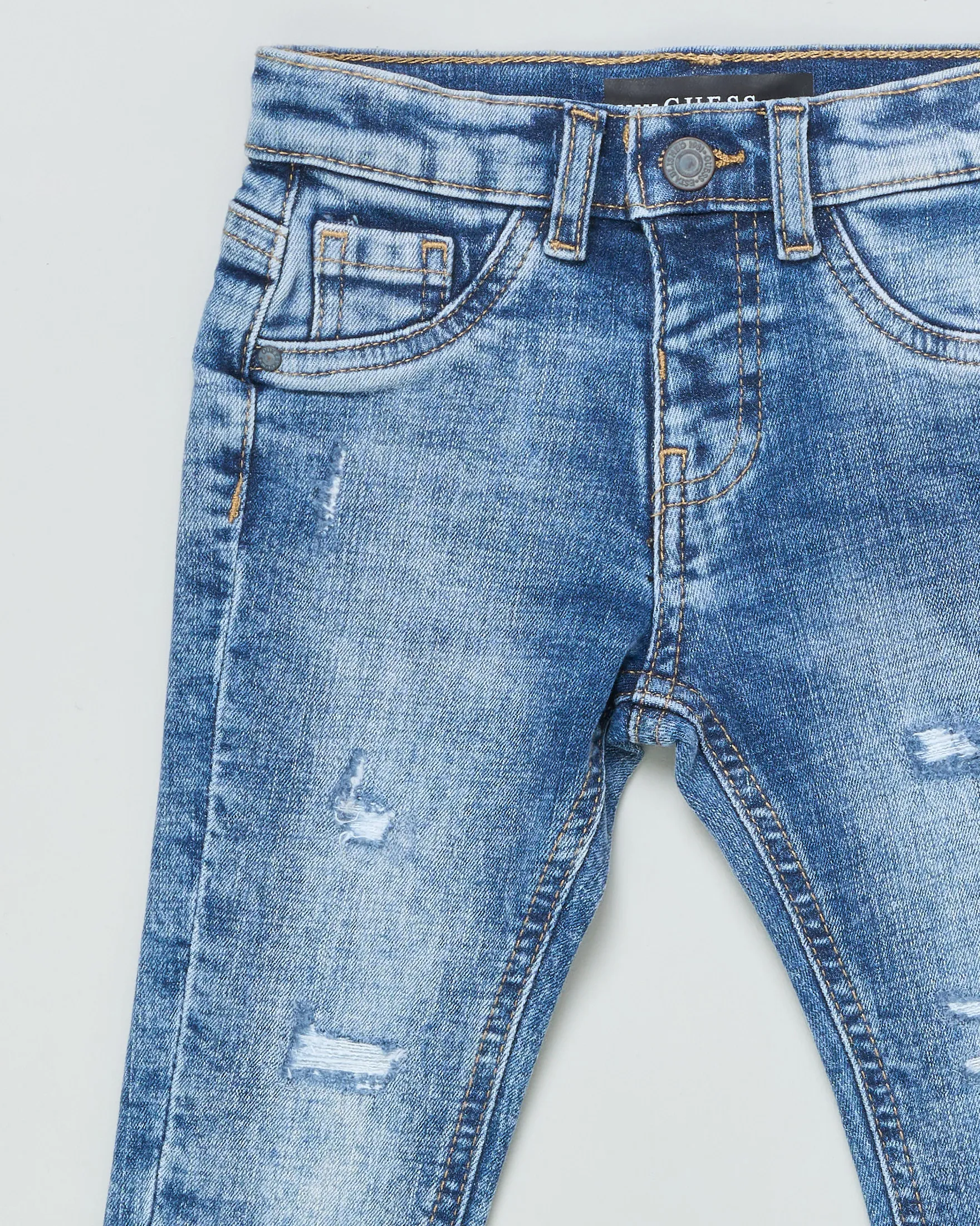 Jeans slim in cotone a lavaggio medio stone washed con abrasioni e micro rotture 12-24 mesi